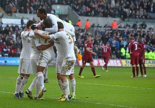 Swansea City's players celebrate Luke Moore's goal at Liberty Stadium in Swansea, south Wales, on March 2, 2013